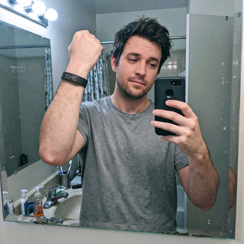 Man taking a mirror selfie wearing the Sweet Sleep Premium Wrist Alarm