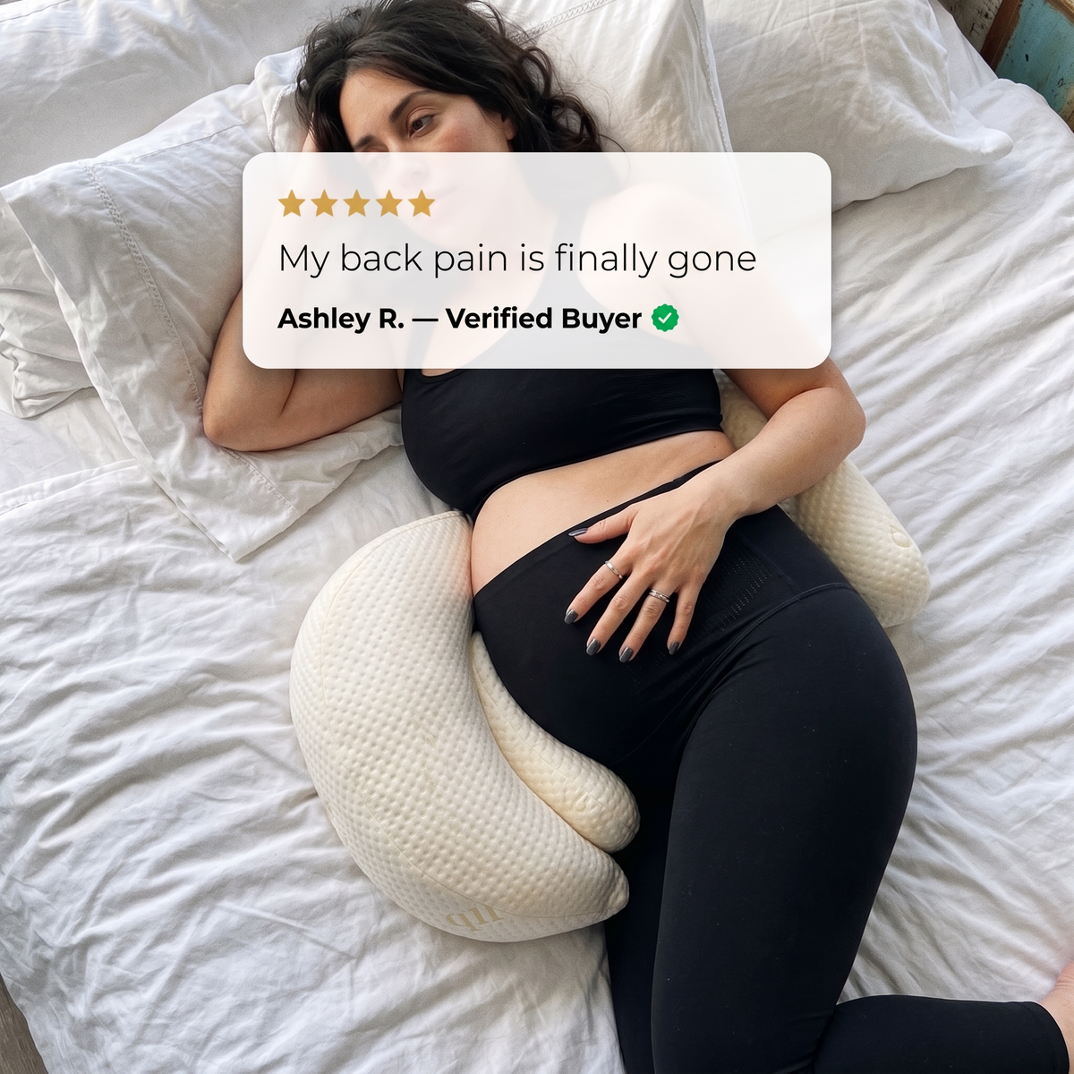 Pregnant woman lying with Bub's Maternity Pillow under her bump