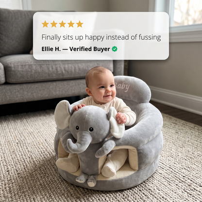 Baby seated in the Sweet Sleep Essential Baby Lounger elephant on a living room rug