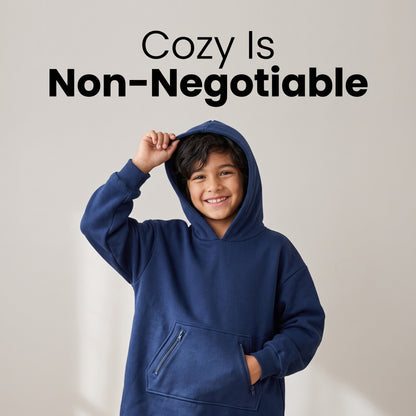 Smiling boy wearing the Sweet Sleep Kids Hug Hoodie with hood up