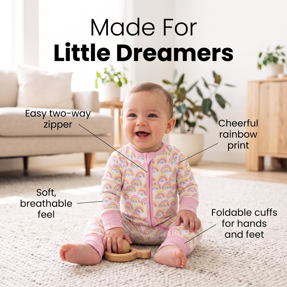Smiling baby sitting in the Sweet Sleep Pastel Rainbows Zippy with two-way zipper and foldable cuffs