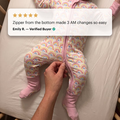 Hands unzipping the Sweet Sleep Pastel Rainbows Zippy from the bottom with a customer review