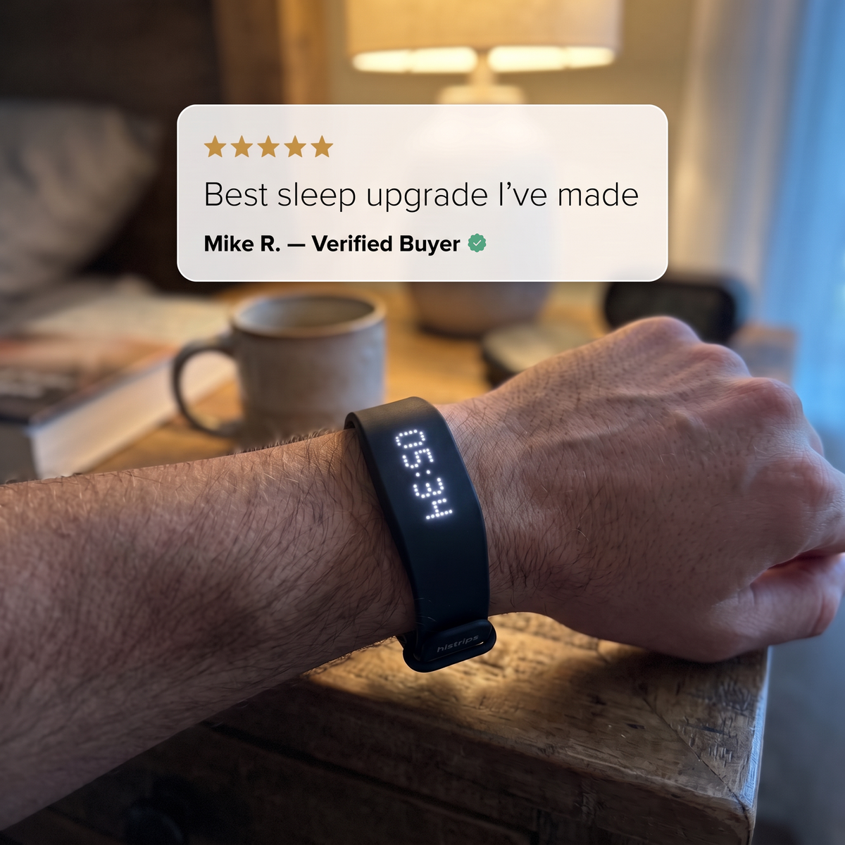 Wrist wearing the Sweet Sleep Premium Wrist Alarm on a bedside table
