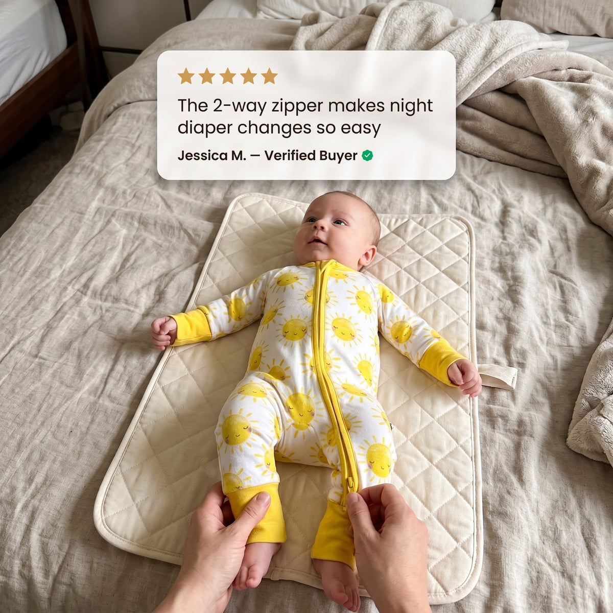 Baby on a changing mat wearing Sweet Sleep Sunshine Zippy with a customer review